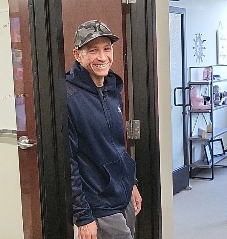 Brian McClement, 2023 men's champion, smiling in a doorway